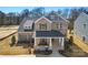 Charming brick two-story home featuring a covered front porch and a well-manicured lawn at 2005 Waxhaw Crossing Dr # 241, Waxhaw, NC 28173