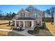 Charming two-story brick home with a covered front porch and a manicured front yard at 2005 Waxhaw Crossing Dr # 241, Waxhaw, NC 28173