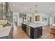 Bright, open kitchen with a large island, seating, stainless steel appliances, and hardwood floors at 2005 Waxhaw Crossing Dr # 241, Waxhaw, NC 28173