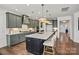 Bright, open kitchen with a large island and pendant lighting, seamlessly connecting to the dining area at 2005 Waxhaw Crossing Dr # 241, Waxhaw, NC 28173