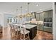 Modern kitchen with a large island, gray cabinets, quartz countertops, and stainless steel appliances at 2005 Waxhaw Crossing Dr # 241, Waxhaw, NC 28173
