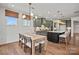 A kitchen and dining area with wooden floors, stylish lighting, and modern appliances at 2005 Waxhaw Crossing Dr # 241, Waxhaw, NC 28173