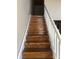 Wooden staircase with white railing offers timeless design at 201 S Hoskins Rd # 328, Charlotte, NC 28208