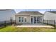 This backyard offers a stone patio, black metal fence, and screened in porch at 20241 Dovekie Ln, Indian Land, SC 29707