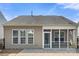 This backyard offers a stone patio, black metal fence, and screened in porch at 20241 Dovekie Ln, Indian Land, SC 29707