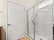 This bathroom features a glass shower with white tiles and a white door at 20241 Dovekie Ln, Indian Land, SC 29707