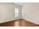 Bedroom with light-colored walls, wood floor, a window and a white door at 20241 Dovekie Ln, Indian Land, SC 29707