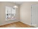 Dining area with wood floors, a window with blinds, and a simple light fixture at 20241 Dovekie Ln, Indian Land, SC 29707