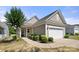 Charming single-story home with a well-manicured lawn and attached two car garage at 20241 Dovekie Ln, Indian Land, SC 29707