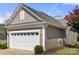 Attached two car garage with white door and low maintenance landscaping at 20241 Dovekie Ln, Indian Land, SC 29707