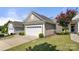Attached two car garage with white door and low maintenance landscaping at 20241 Dovekie Ln, Indian Land, SC 29707