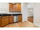 Kitchen featuring stainless steel appliances, wooden cabinets and an opening to another room at 20241 Dovekie Ln, Indian Land, SC 29707