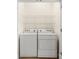 Laundry area features a standard white washer and dryer with metal shelving above at 20241 Dovekie Ln, Indian Land, SC 29707