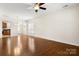 Spacious living room with hardwood floors, ceiling fan, and lots of natural light at 20241 Dovekie Ln, Indian Land, SC 29707