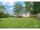 Spacious backyard featuring a wooden deck, lush green grass, and partial fencing for privacy at 2509 1St St, Statesville, NC 28677