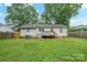 Expansive backyard with well-maintained lawn, leading to a charming wooden deck and fenced perimeter at 2509 1St St, Statesville, NC 28677