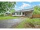 Charming single-story home with a covered carport and well-maintained front yard with partial fence at 2509 1St St, Statesville, NC 28677
