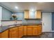 Cozy kitchen with granite counters, light wood cabinetry, and stainless steel sink at 2509 1St St, Statesville, NC 28677