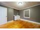 Gray laundry room with white washer and dryer, wood floors, and natural light at 2509 1St St, Statesville, NC 28677