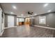 Spacious living room featuring modern gray walls, hardwood floors, and stainless steel appliances at 2509 1St St, Statesville, NC 28677