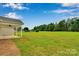 Large backyard with well-maintained lawn and view of the woods at 275 Dorothy Dr, China Grove, NC 28023