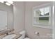 Cozy bathroom featuring natural light from the window and a granite countertop vanity at 275 Dorothy Dr, China Grove, NC 28023