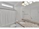 Full bathroom featuring a granite countertop vanity and a shower/tub combination with a white shower curtain at 275 Dorothy Dr, China Grove, NC 28023