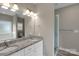 Bathroom features a double vanity with granite countertop and glass shower at 275 Dorothy Dr, China Grove, NC 28023