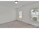 Neutral bedroom with two bright windows, light colored carpet, and fresh paint at 275 Dorothy Dr, China Grove, NC 28023