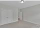 Neutral bedroom features a double door closet and an additional doorway to an adjacent room at 275 Dorothy Dr, China Grove, NC 28023