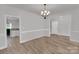 Dining room showcasing laminate wood floors, open concept floor plan, and chandelier at 275 Dorothy Dr, China Grove, NC 28023