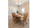 Bright dining room featuring a wood table, chairs, and a chandelier, with a view into another room at 275 Dorothy Dr, China Grove, NC 28023