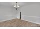 Well-lit dining room showcasing wainscoting, laminate wood floors and a decorative chandelier at 275 Dorothy Dr, China Grove, NC 28023