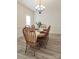 Bright dining room features a wood table with six chairs, a decorative chandelier, and light gray wood flooring at 275 Dorothy Dr, China Grove, NC 28023