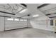 Spacious two car garage with sealed concrete flooring, overhead storage racks, and abundant lighting at 275 Dorothy Dr, China Grove, NC 28023