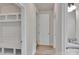 Bright hallway with wood floors leading to bathroom and built-in shelving at 275 Dorothy Dr, China Grove, NC 28023