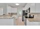 Bright kitchen with white cabinets, granite countertops, stainless steel appliances, and modern fixtures at 275 Dorothy Dr, China Grove, NC 28023
