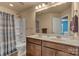 Beautiful bathroom featuring a double sink vanity with dark wood cabinets, a large mirror, and a shower-tub combo at 3159 Hartson Pointe Dr, Fort Mill, SC 29707