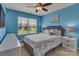 Bright bedroom featuring blue walls, a ceiling fan, a comfortable bed, and natural light from the window at 3159 Hartson Pointe Dr, Fort Mill, SC 29707