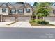 Charming townhome with a two-car garage, stone accents, and manicured landscaping creates excellent curb appeal at 3159 Hartson Pointe Dr, Fort Mill, SC 29707