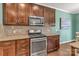 Kitchen with stainless steel appliances, granite countertops, and dark brown cabinets at 3159 Hartson Pointe Dr, Fort Mill, SC 29707