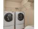 Convenient laundry room with side-by-side washer and dryer, maximizing space efficiency with overhead storage at 3159 Hartson Pointe Dr, Fort Mill, SC 29707