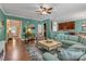 Cozy living room featuring a large sofa, hardwood floors, and entry to the foyer and kitchen at 3159 Hartson Pointe Dr, Fort Mill, SC 29707
