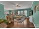 Bright living room boasts hardwood floors, ceiling fan, large windows, and access to the dining room at 3159 Hartson Pointe Dr, Fort Mill, SC 29707