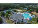Stunning aerial view of neighborhood pool and clubhouse featuring tennis courts, volleyball court, lake, and lush landscaping at 3159 Hartson Pointe Dr, Fort Mill, SC 29707