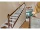 Elegant staircase with hardwood steps and white railings, flowing into an open-concept living area at 3159 Hartson Pointe Dr, Fort Mill, SC 29707
