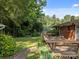 View of the backyard, wooden deck, brick path, and mature landscaping at 331 Elwood St, Kannapolis, NC 28081