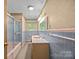 Bathroom features a shower and tub combination with a window above the sink at 331 Elwood St, Kannapolis, NC 28081