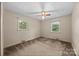 Bright bedroom with carpet and two windows offering backyard views at 331 Elwood St, Kannapolis, NC 28081