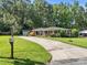 Quaint brick home with a long driveway and detached garage nestled among mature trees at 331 Elwood St, Kannapolis, NC 28081
